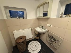 a small bathroom with a sink and a toilet at Ferienwohnung Silbergarten in Clausthal-Zellerfeld
