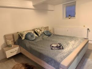 a bedroom with a bed with a gray comforter at Ferienwohnung Silbergarten in Clausthal-Zellerfeld