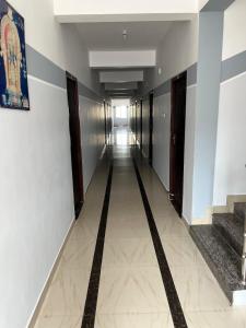 a long hallway with a long corridor with stairs at Velan view in Palni