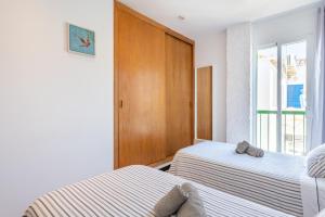 a bedroom with two beds and a window at Can Marineta in Palma de Mallorca