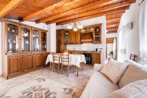 a kitchen with wooden cabinets and a table with chairs at Su Niu de Arbus in Arbus +12 photos