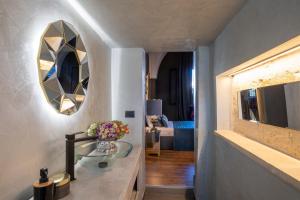 a bathroom with a glass sink and a mirror at Maison Boutique At Daniela in San Pietro in Lama
