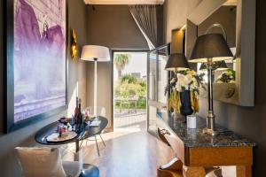 a living room with a table with a vase of flowers at Maison Boutique At Daniela in San Pietro in Lama