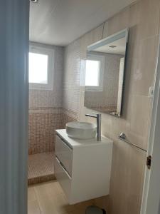 a bathroom with a sink and a mirror at Studio 2 Sea front in Rincón de la Victoria