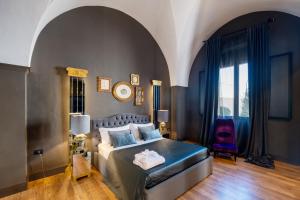a bedroom with a bed and a chair in it at Maison Boutique At Daniela in San Pietro in Lama +36 photos