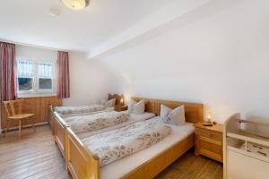 a bedroom with three beds in a room at Hofgut Dürrenbühl in Grafenhausen