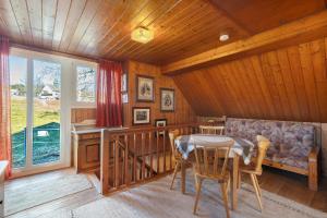 a dining room with a table and chairs in a cabin at Hofgut Dürrenbühl in Grafenhausen
