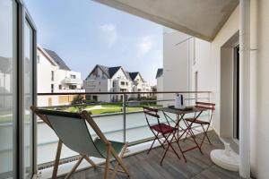 a balcony with a table and chairs and a view at Cocon Terrasse près du Port - A102 in Pornic