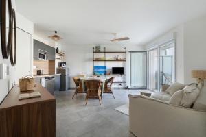 a living room with a table and a couch at Cocon Terrasse près du Port - A102 in Pornic