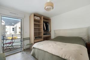 a bedroom with a large bed and a window at Cocon Terrasse près du Port - A102 in Pornic