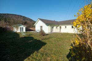a white house with a yard with a house at Villa Green in Saint-Amé