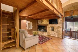 a living room with a chair and a stone fireplace at Apulia Luxury House in Toritto