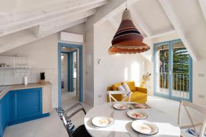 a kitchen and living room with a table and chairs at Saint Claude in Marina di Andora