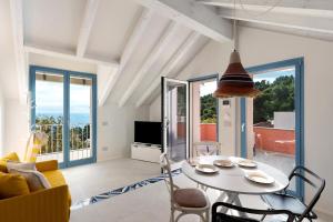 a living room with a table and chairs at Saint Claude in Marina di Andora