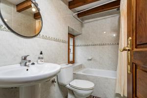 a bathroom with a sink and a toilet and a tub at Casa Rural Ricao in Cangas de Onís +17 photos