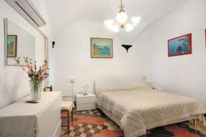 a bedroom with a bed and a vase of flowers at Casa Paola in Levanto
