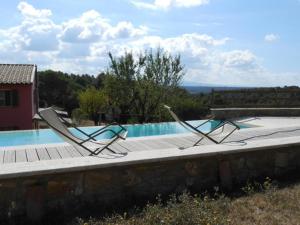two chairs sitting next to a swimming pool at Piccolo Paradiso - Riparbella in Riparbella
