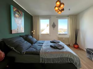 a bedroom with a bed and two windows at Ferienwohnung Ate´s kleine Welt in Brilon