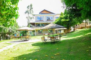 a group of tables and chairs in front of a building at Fairways Hotel in Narok