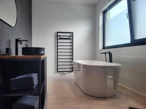 a bathroom with a bath tub and a window at Ferienhaus Schlossterrassen 4a in Pouch +11 photos