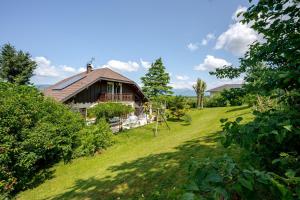 a house on a hill with a green yard at Villa près du lac in Étercy