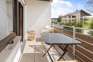 a black table on the balcony of a house at Isabell in Schönwald