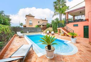 a swimming pool in the backyard of a house at Pareado Relax in Marbella