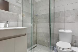a bathroom with a shower and a toilet and a sink at Villa Dionysia Apartment A2 in Alikanas +18 photos