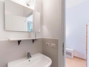 a white bathroom with a sink and a mirror at Delicious House Michelangelo in Cavaion Veronese +20 photos