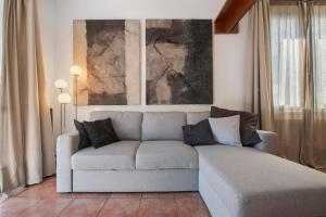 a living room with a couch and a painting at Lake Como Design Home in Lecco