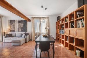 a living room with a table and a couch at Lake Como Design Home in Lecco