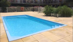 a large blue swimming pool on a patio at Appartement Ty Avel in Quiberon