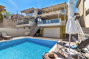 a villa with a swimming pool and a building at Evagelia Luxury Apartment 2 in Nikiana