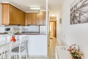 a kitchen and dining room with a table and chairs at Platja Mar 3º in L'Escala