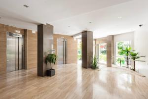 an empty lobby with potted plants in a building at Estudios 79 in Torrox