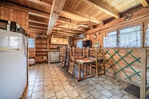 a kitchen with a refrigerator and a table at Chalet 6p Classique - Le Marmotton in Verchaix