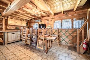 a kitchen with wooden walls and a table in a room at Chalet 6p Classique - Le Marmotton in Verchaix +12 photos