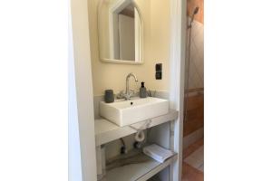 a bathroom with a sink and a mirror at Studio Episkopos in Nikiana
