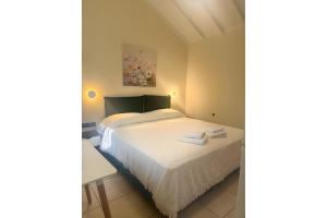 a small bedroom with a bed and a table at Studio Episkopos in Nikiana +10 photos