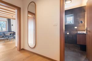 a hallway with a mirror and a dining room at La Grambla App Mont Seuc 1 in Santa Cristina Gherdëina +26 photos