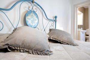 a bed with two pillows on top of it at Casa Miki in Sarnico