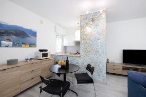 a kitchen and dining room with a table and chairs at Casa Miki in Sarnico +23 photos
