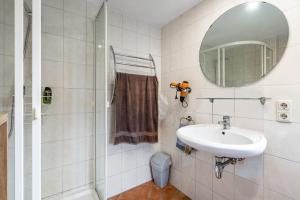 a bathroom with a sink and a mirror at Bungalow 73 in Zadelsdorf +14 photos