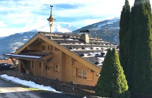a building with a clock tower on top of it at Chalet Sonnberg Bramberg in Bramberg am Wildkogel