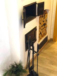 a fireplace with a tv on a wall with a fire place at Chalet Sonnberg Bramberg in Bramberg am Wildkogel