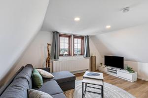a living room with a couch and a tv at Werner-Senger-Haus Limburg in Limburg an der Lahn