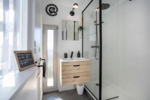 a bathroom with a sink and a shower at Superbe Duplex en centre ville in Douarnenez +14 photos