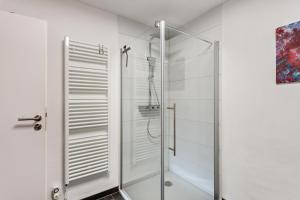 a glass shower stall in a white bathroom at Haus Frigger in Olsberg +19 photos