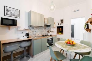a kitchen with a table with a bowl of fruit on it at Casa Margherita in Matino
