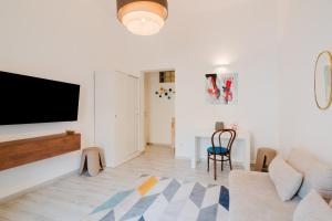 a living room with a flat screen tv on a wall at Casa Margherita in Matino